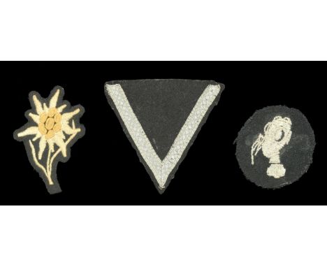 German Second World War S.S. Insignia. Comprising a machine embroidered grey on black mountain troopers edelweiss badge; a sc