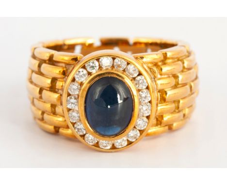 Bezel set to the center with a cabochon sapphire weight approximately 1.30 carats, surrounded by channel set diamonds weight 