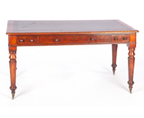 The rectangular top with tooled leather inset writing surface above frieze drawers, on turned and ring-turned tapering legs w