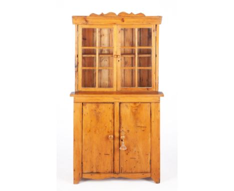 With shaped cornice above a pair of glazed panel doors, the lower section with a pair of cupboard doors, on stile feet147cm h