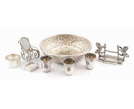 Comprising three near matching wine cups, a shaped circular plate, a bookend ,a rocking chair , a serviette ring and a matchb