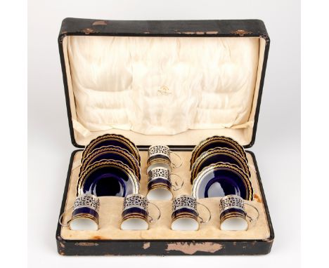 The cobalt blue cups and saucers with gilt highlights, comprising: 6 cups, 6 saucers and 6 cup holders, in original presentat