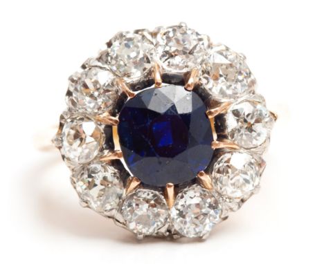 Claw set to the center with a old cut sapphire weight approximately 1,20 carats, embellished around by 10 old cut diamonds we