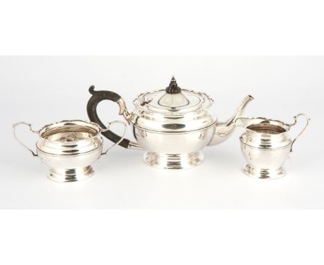 Mappin &amp; Webb, Birmingham 1923, comprising a teapot, milk jug and sugar basin, the circular bodies with moulded girdles, 