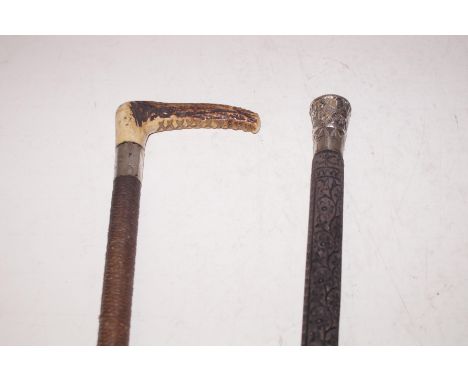 Antler handled whip with silver collar together with a silver handled swagger stick