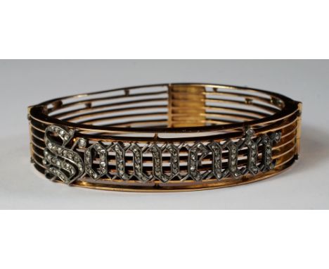 A French gold and diamond set hinged bangle, of seven knife-edge gold bars, sprinkled with diamond chips and applied with the