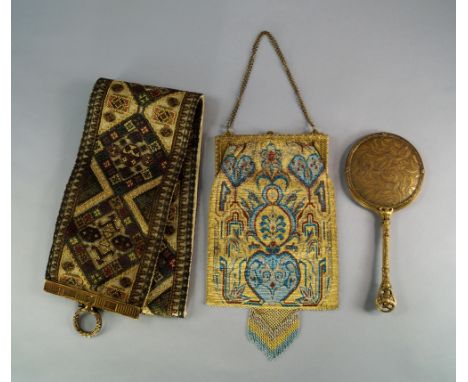 A metallic beaded handbag, c.1910, of rectangular form, the metal beads in shades of gold, bronze and blue, with cast gilt me