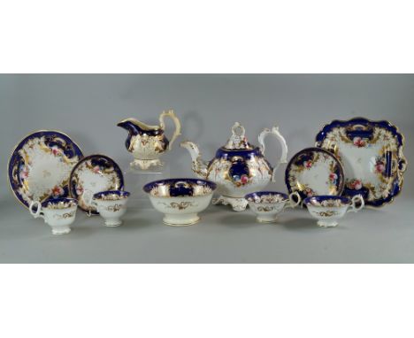 An English porcelain part tea and coffee service, 19th century, decorated overall to the rims with gilt leaves and trailing t