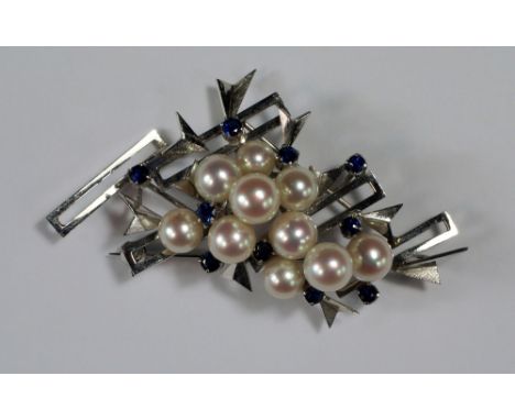 An 18ct white gold, sapphire and pearl brooch, c.1970s, by Manning, of abstract form, with open white gold rectangles and arr