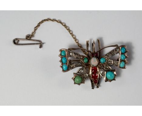 A gem set butterfly brooch, 19th century, set with opal, ruby, turquoise and rough cut diamonds, set in unmarked yellow metal