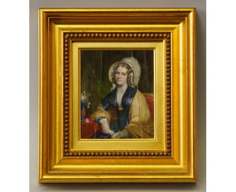 A Portrait Miniature, British School, mid 19th century, depicting a lady seated three-quarter length turned to the left, in a