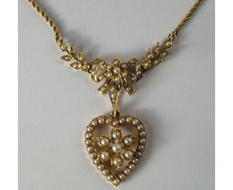 A 19th century unmarked yellow metal and seed pearl set necklace, the rope chain leading a seed-pearl set bow flanked by leav