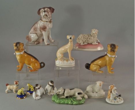 A pair of German porcelain models of pug dogs, late 19th/20th century, 12.5cm high, together with a collection of other Briti