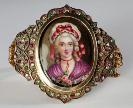 A hinged gem set portrait bangle, 19th century, the enamel miniature depicting an 18th century lady in a mop cap with pink ri