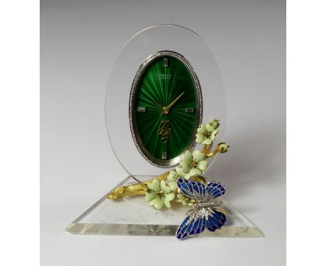 An 18ct gold, rock crystal and diamond set desk clock, by Vincci, London, 1984, the 18ct gold clock case with oval green enam