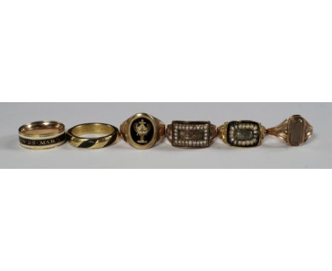 A collection of late 18th and 19th century memoriam rings, to include a spinner ring with double sided glazed locket with pla