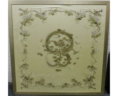 Japanese embroidered silk work panel depicting a Dragon chasing the flame, the pearl of wisdom amidst stylised flowers and fo