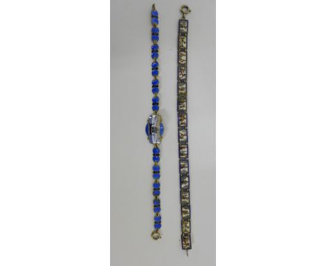A silver and blue enamel viking bracelet and a another panel bracelet  with enamel plaques depicting Egyptian motifs and figu