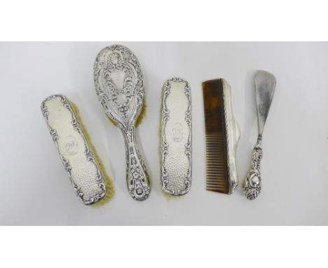 Silver backed dressing table items to include a hairbrush, shoe horn, comb and two clothes brushes (various marks and dates) 