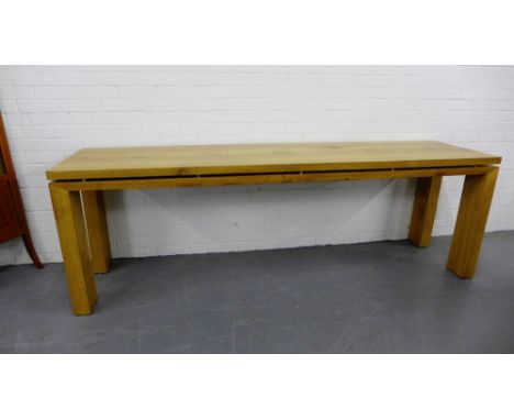 A contemporary light oak hall table with a floating top on block supports, 77 x 236cm