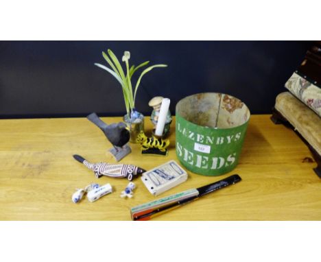 A Lazenbys seeds green painted tub containing a variety of items to include a painted bird, Japanese fan, an Aboriginal lizar