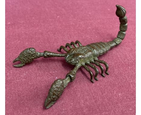 A small Japanese bronze articulated figure of a scorpion. With moving pincers and bendable tail. Approx. 4cm tall x 9cm long.