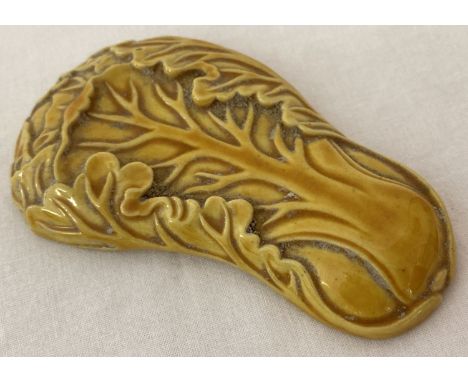 A small ceramic yellow glazed scroll weight in the form of a Chinese cabbage.  Approx. 10cm long.