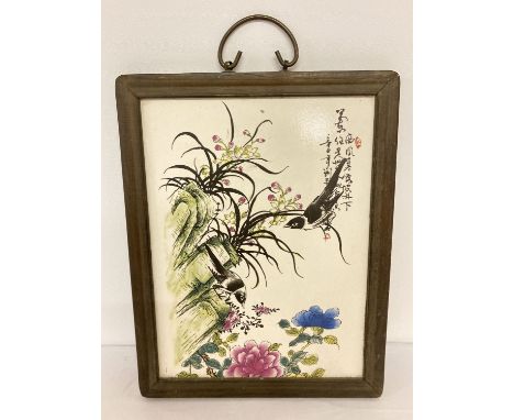 A signed porcelain Chinese ceramic plaque depicting birds and flowers. Mounted in a wooden frame with handle to top. Approx. 