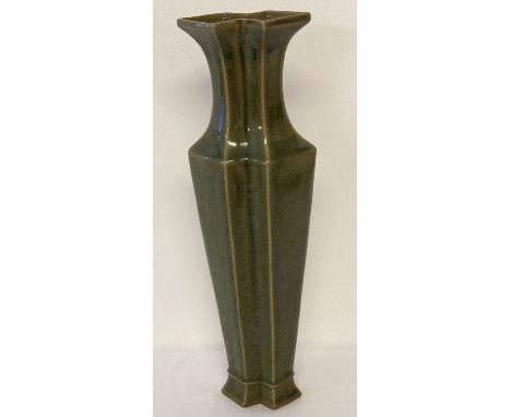 A tall slim dark green glaze vase of double diamond shape, with engraved signature to base.  Approx. 40cm tall.