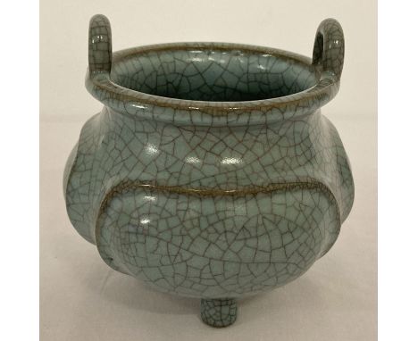 A blue/green crackle glaze ceramic censer, with loop handles and tripod feet.  Approx. 12cm tall x 12cm diameter.