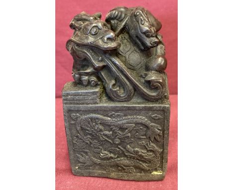 A large square shaped hollow bronze seal featuring a dragon turtle. Four panel sides depicting dragons, Chinese symbols to un