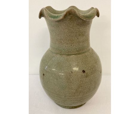 A green crackle glaze ceramic vase with a scalloped rim.  Approx. 17cm tall.