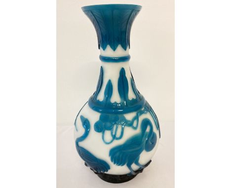 A Chinese Peking glass vase. Petrol blue carved overlay decorated with cranes and leaves.  Approx. 24cm tall.