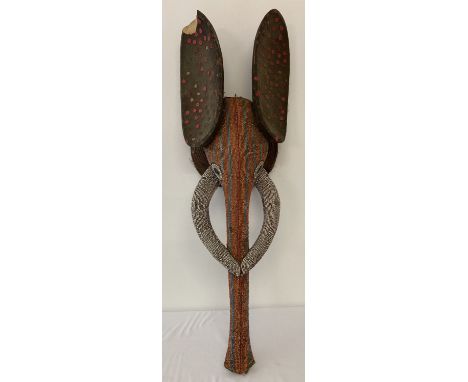A carved wooden tribal art head of an elephant. Heavily beaded decoration to head, trunk and tusks. Sequin style decoration t