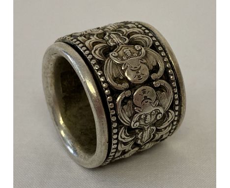 A Chinese white metal Archers ring with decorative central rotating panel featuring fu bat.  Approx. 3cm diameter.