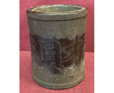 A heavy bronze brush pot with calligraphy detail.  Approx. 10cm tall x 8cm diameter.