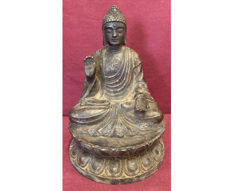 A circular based hollow bronze figure of seated Buddha atop a lotus flower.  Approx. 18.5cm tall.