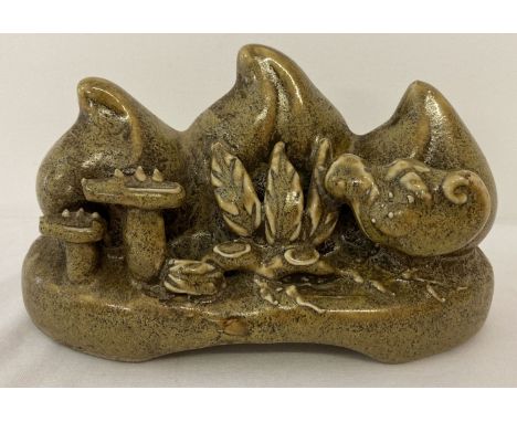 A Chinese ceramic brush rest in the form of peaches, in a brown green speckled glaze.  Approx. 9cm tall x 16cm long.