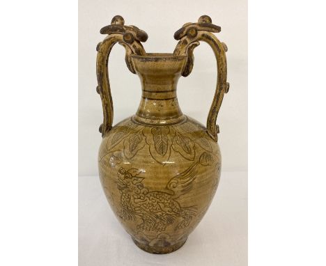 A ceramic 2 handled urn with yellow/brown glaze and hand painted dragon detail.  Approx. 21.5cm tall.