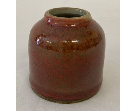 A small Chinese ceramic brush pot with orange speckled glaze. Blue ring mark to underside. Approx. 6cm tall x 6cm diameter.
