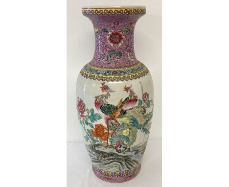 A large Chinese porcelain Famille Rose vase. Decorated with painted exotic birds and peonies Approx. 45cm tall.