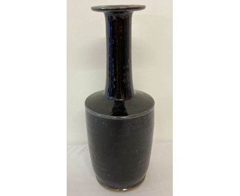 A long necked, black glazed ceramic vase with wide rim.  Approx. 30.5cm tall.