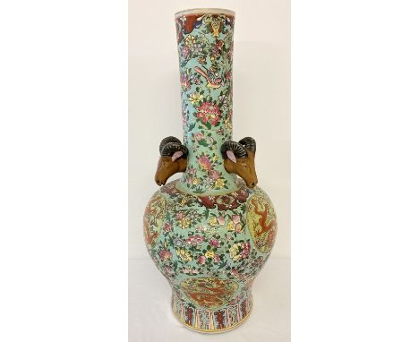 A very large ceramic long necked vase, decorated with peaches, birds and floral design. With dragon panel detail and rams hea