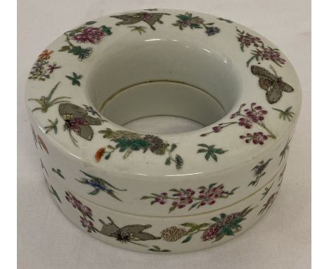 A Chinese ring shaped porcelain lidded trinket pot with hand painted butterfly and floral detail.  Approx. 14.5cm diameter.