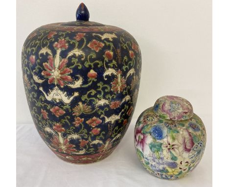 2 Oriental ceramic lidded jars with hand painted detail. A small bulbous jar decorated with floral design together with a lar