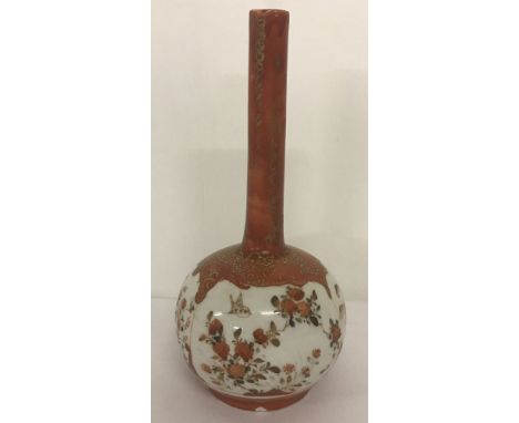 A small oriental vase with floral and bird decoration, in orange and gilt colours.  Total height approx. 18cm.