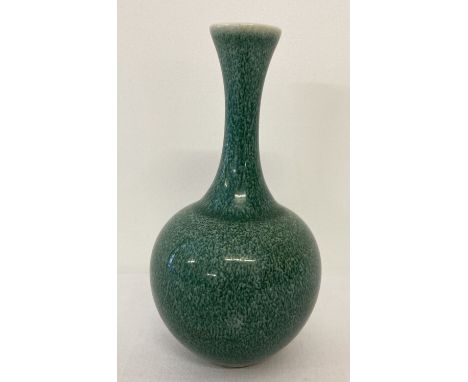 A small ceramic slim necked vase with dark green speckled glaze and ring mark to underside.  Approx. 16cm tall.