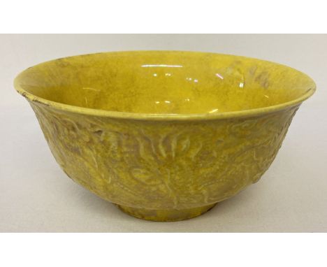 A Chinese ceramic bowl with yellow lustre glaze and raised dragon detail to outer bowl. Signed to underside. Approx. 7cm tall
