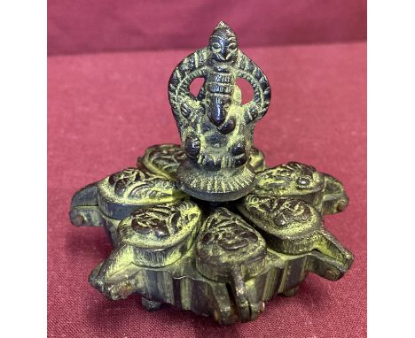 An Indian bronze 7 sectional spice box. With central screw down finial and hinged lid spice compartments. Approx. 6.5cm tall 