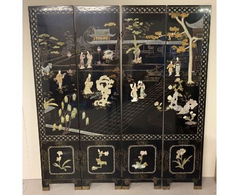 A vintage black lacquer 4 sectional room divider with mother of pearl inlay and gilt detail. Featuring figural scene and flow